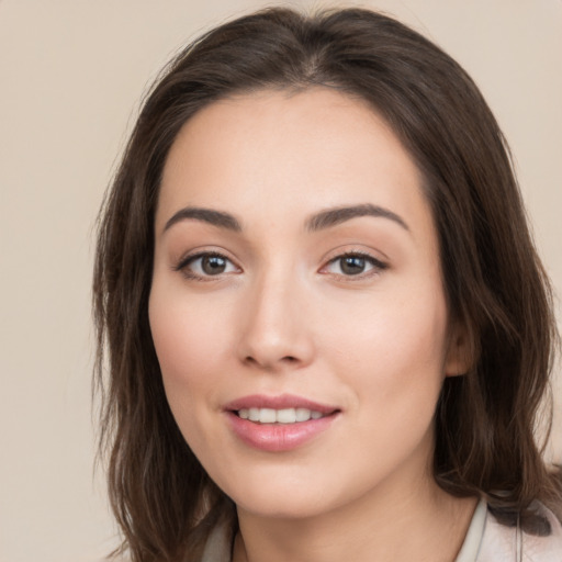 Joyful white young-adult female with long  brown hair and brown eyes