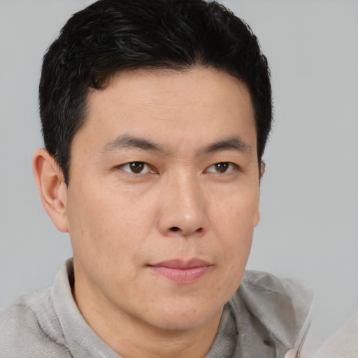 Neutral asian young-adult male with short  brown hair and brown eyes