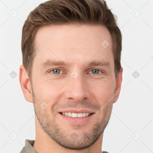 Joyful white young-adult male with short  brown hair and grey eyes