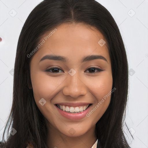 Joyful latino young-adult female with long  brown hair and brown eyes