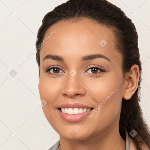 Joyful white young-adult female with long  brown hair and brown eyes