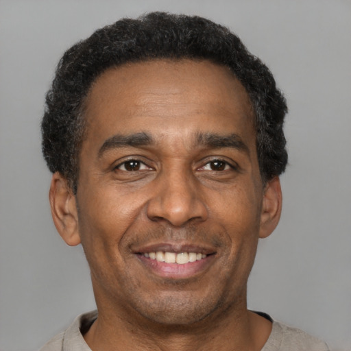 Joyful latino adult male with short  black hair and brown eyes