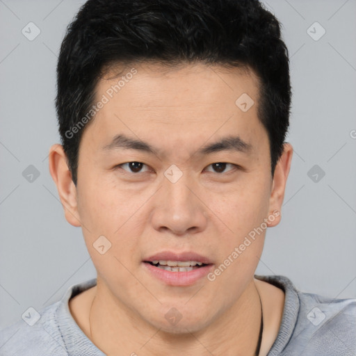 Joyful asian young-adult male with short  brown hair and brown eyes