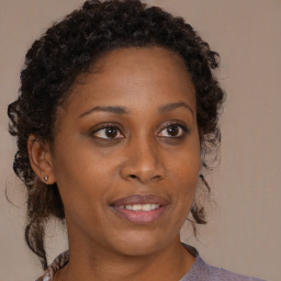 Joyful black adult female with medium  brown hair and brown eyes