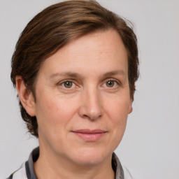 Joyful white adult female with medium  brown hair and grey eyes