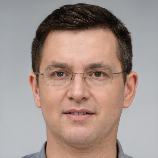 Joyful white adult male with short  brown hair and grey eyes