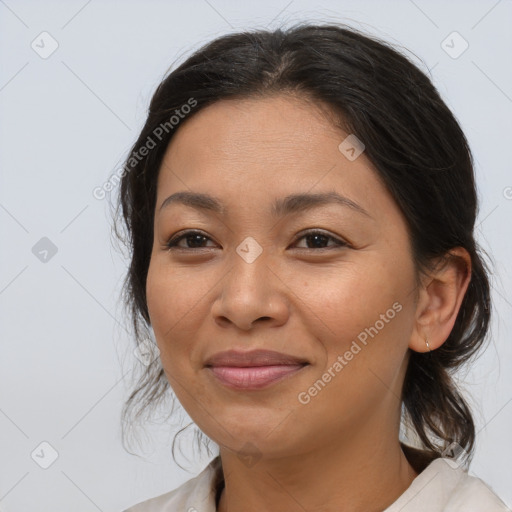 Joyful latino young-adult female with medium  brown hair and brown eyes