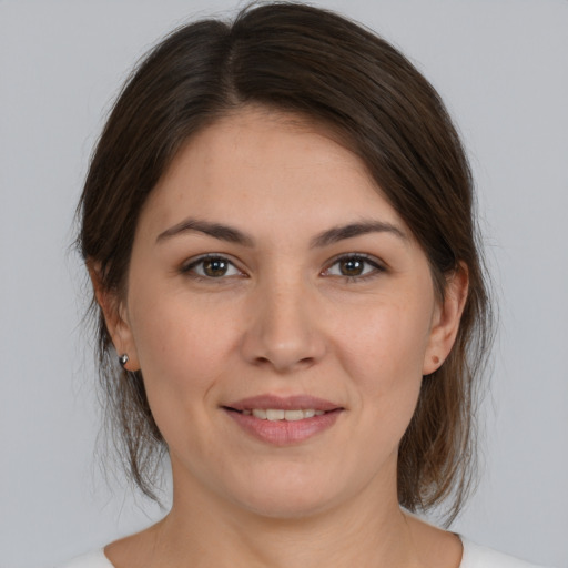 Joyful white young-adult female with medium  brown hair and brown eyes