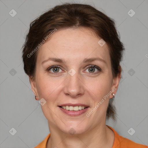 Joyful white adult female with medium  brown hair and grey eyes