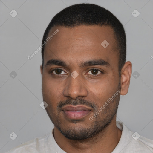 Joyful black young-adult male with short  black hair and brown eyes