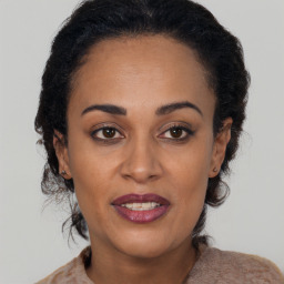 Joyful black young-adult female with medium  brown hair and brown eyes