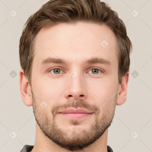 Joyful white young-adult male with short  brown hair and grey eyes