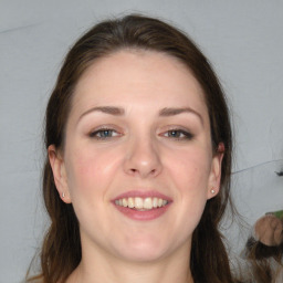 Joyful white young-adult female with long  brown hair and grey eyes