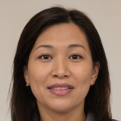 Joyful asian adult female with medium  brown hair and brown eyes