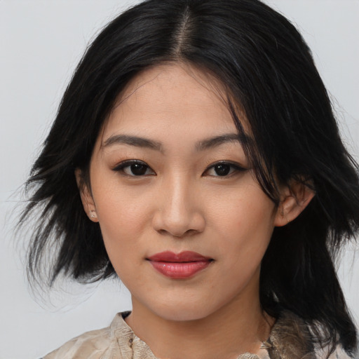 Joyful asian young-adult female with medium  black hair and brown eyes