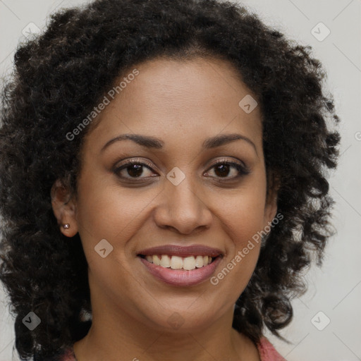 Joyful black young-adult female with long  brown hair and brown eyes