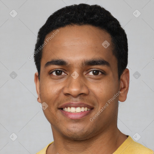 Joyful black young-adult male with short  black hair and brown eyes