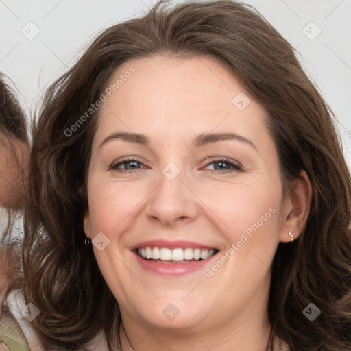 Joyful white adult female with long  brown hair and brown eyes