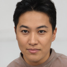 Joyful asian young-adult male with short  brown hair and brown eyes