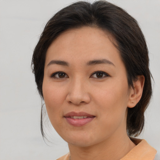 Joyful asian young-adult female with medium  brown hair and brown eyes