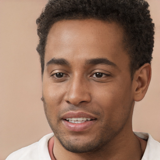 Joyful black young-adult male with short  brown hair and brown eyes