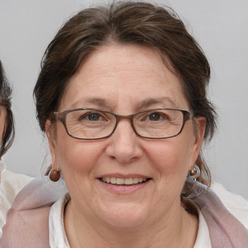 Joyful white middle-aged female with medium  brown hair and blue eyes