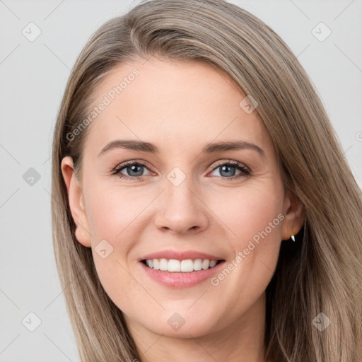 Joyful white young-adult female with long  brown hair and grey eyes