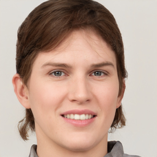 Joyful white young-adult female with medium  brown hair and grey eyes