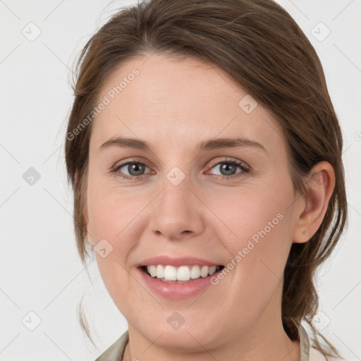 Joyful white young-adult female with medium  brown hair and grey eyes