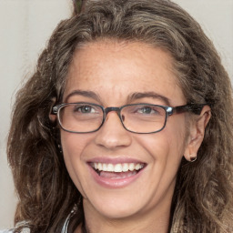 Joyful white adult female with long  brown hair and brown eyes