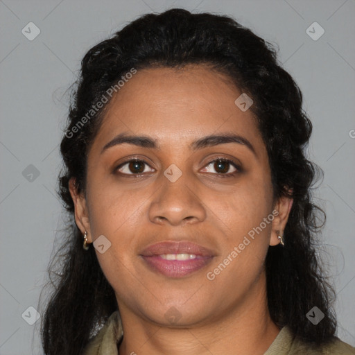 Joyful black young-adult female with long  brown hair and brown eyes