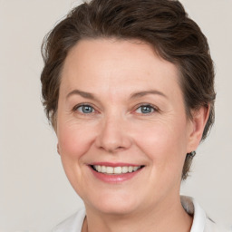 Joyful white adult female with medium  brown hair and grey eyes