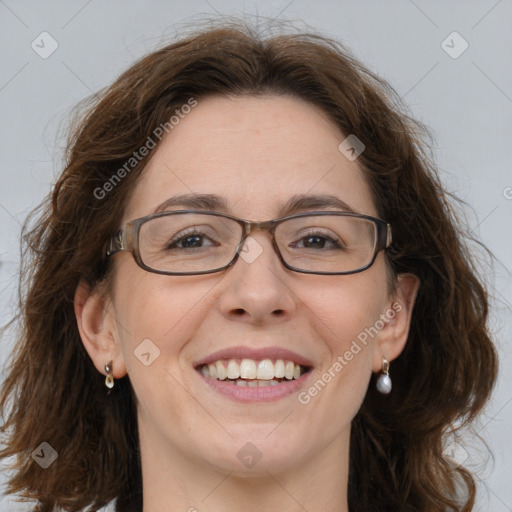 Joyful white adult female with medium  brown hair and blue eyes