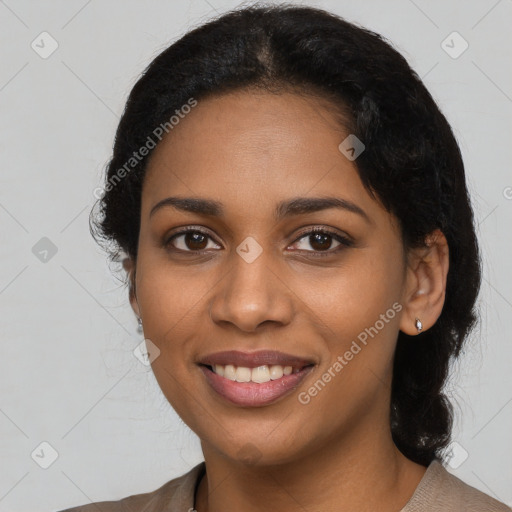 Joyful black young-adult female with long  black hair and brown eyes