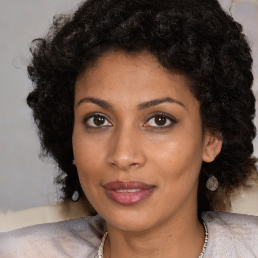 Joyful black young-adult female with medium  brown hair and brown eyes