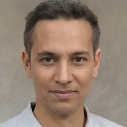 Joyful white adult male with short  brown hair and brown eyes