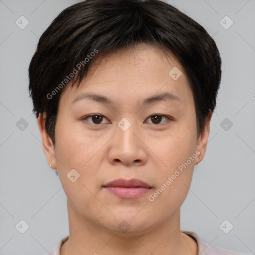 Joyful asian young-adult female with short  brown hair and brown eyes