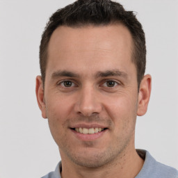 Joyful white young-adult male with short  brown hair and brown eyes