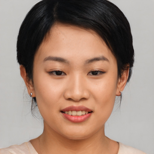 Joyful asian young-adult female with medium  black hair and brown eyes