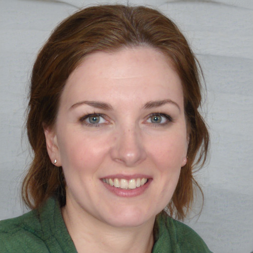 Joyful white young-adult female with medium  brown hair and blue eyes