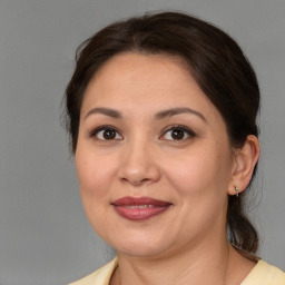 Joyful white adult female with medium  brown hair and brown eyes