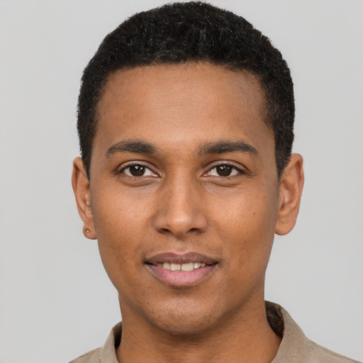 Joyful black young-adult male with short  brown hair and brown eyes