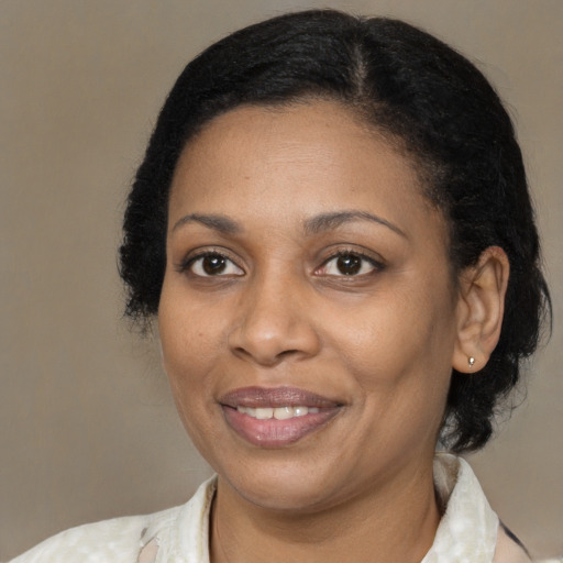 Joyful black adult female with medium  black hair and brown eyes