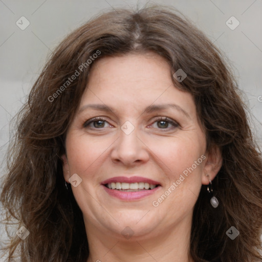 Joyful white adult female with long  brown hair and grey eyes