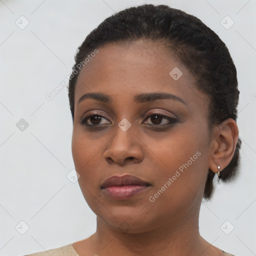 Joyful black young-adult female with short  black hair and brown eyes