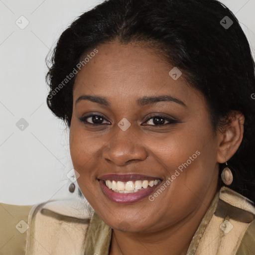 Joyful black young-adult female with long  brown hair and brown eyes