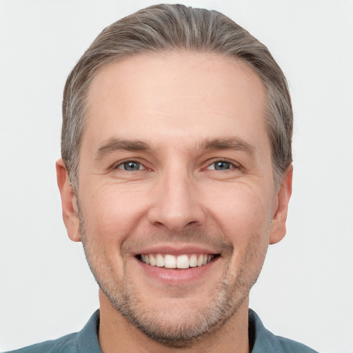 Joyful white adult male with short  brown hair and grey eyes