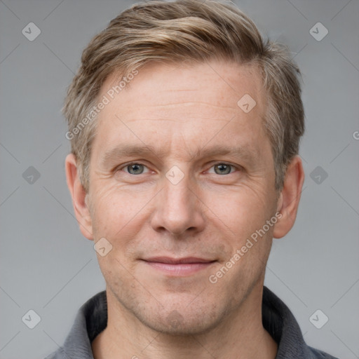 Joyful white adult male with short  brown hair and grey eyes