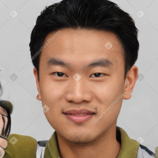 Joyful asian young-adult male with short  black hair and brown eyes