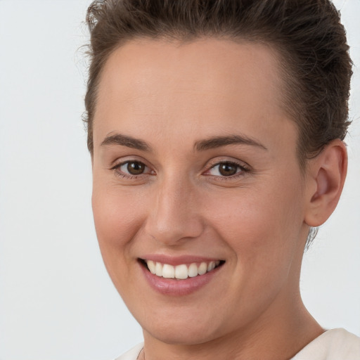 Joyful white young-adult female with short  brown hair and brown eyes